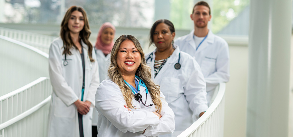 Medical providers on stairs in lab coats 
